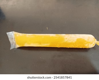 Frozen Yellow Ice Pop in Plastic Wrapper