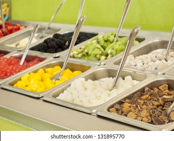 Frozen Yogurt Toppings Bar. Yogurt Toppings Ranging From Fresh Fruits, Nuts, Fresh-cut Candies, Syrups And Sprinkles.