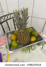 A fruit basket with Pineapple with 2 crowns