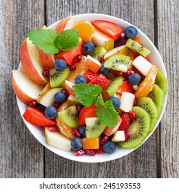 Fruit And Berry Salad On Wooden Table, Top View, Close-up