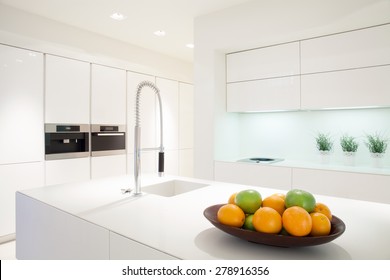 Fruit In A Bowl On The Marble Island In White Kitchen