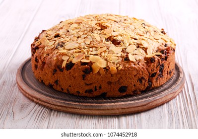 Fruit cake with almond topping on board