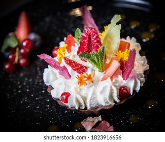 Fruit cake dessert with cream and edible flowers