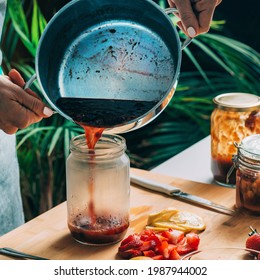 Fruit Canning At Home. Woman Pouring Cooked Jam Into Sterile Jars. Fruit Preservation.