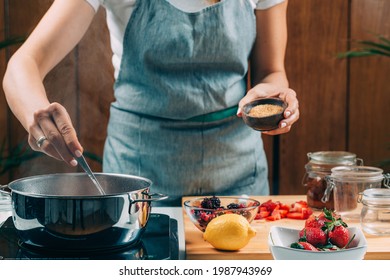 Fruit Canning Preservation. Woman Cooking Fruits And Making Homemade Jam.