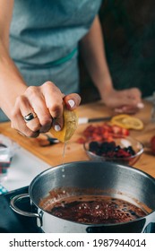 Fruit Canning Preservation. Woman Cooking Fruits And Making Homemade Jam. Squeezing Lemon. 