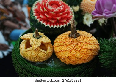 Fruit carving decorations featuring pumpkins, cantaloupes, and melons; beautiful and delicate professional craftsmanship in Thai style.