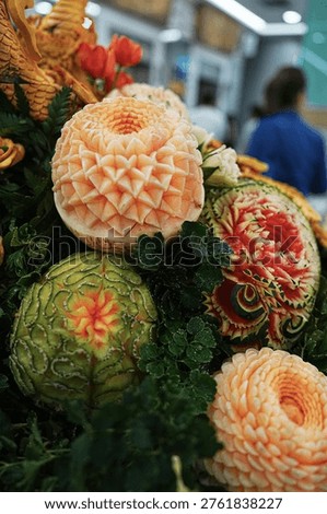 Fruit carving decorations featuring pumpkins, cantaloupes, and melons; beautiful and delicate professional craftsmanship in Thai style.