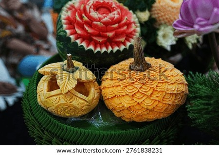 Fruit carving decorations featuring pumpkins, cantaloupes, and melons; beautiful and delicate professional craftsmanship in Thai style.