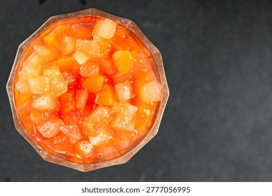 Fruit cocktail pineapple, mango, lychee, apple Canned fruit cocktail tasty snack fresh food background on the table, rustic food, top view, copy space vegetarian and vegan food