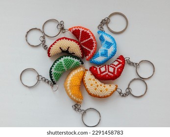 Fruit colorful key chains on a white. Bead colorful key chains on a white background