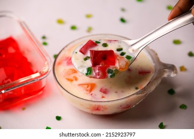 Fruit custard in a glass bowl,jelly custard,tutti frooti custard,milk custard closeup with selective focus and blur