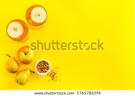 Fruit drinks with apple and pear on yellow background from above copy space