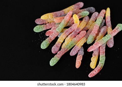 Fruit Gummy Candy Worms On A Dark Background With Space For Text