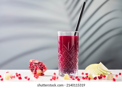 Fruit juice, pomegranate juice on a marble table, on a soft focus background - Shutterstock ID 2140115319