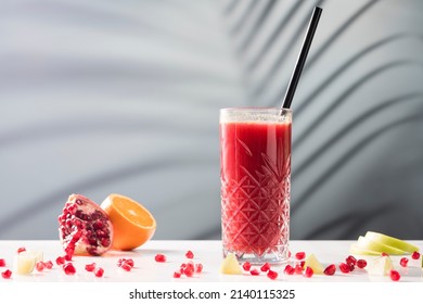 Fruit juice, pomegranate and orange juice on a marble table, on a soft focus background - Shutterstock ID 2140115325
