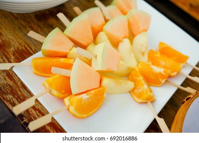 Fruit Kebabs ,Fruit Skewer With Cantaloupe, Orange, Apple On White Dish