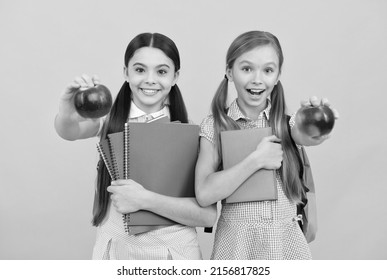 Fruit Of Knowledge. Happy Teen Girls With Books Show Apples. Food Knowledge