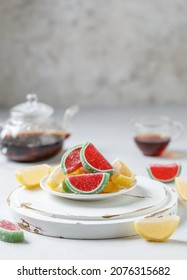 Fruit marmalade on white background. Slices of marmalade sprinkled with granulated sugar