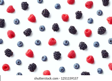 Fruit pattern of colorful wild berries isolated on white background. Raspberries, blueberries and blackberries. Top view. Flat lay