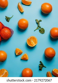 Fruit Pattern With Fresh Oranges, Slices And Glass Of Refreshing Drink On Vivid Blue Background. Creative Summer Food Concept. Minimal Pop Art Vegetarian Meal. Flat Lay, Top View.