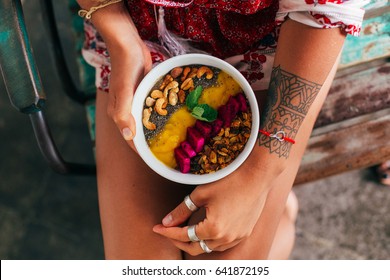 Fruit plate with granola. Exotic fruits. Girl's healthy breakfast