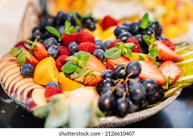 Fruit Platter On A Plate For A Festive Table. Berries And Chopped Fruits Is A Delicious And Healthy Vegetarian Dessert. Catering.