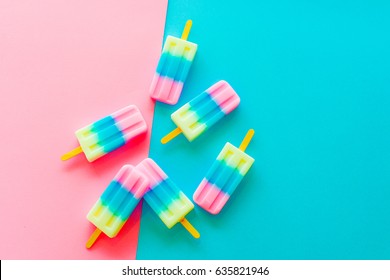 Fruit popsicle / ice cream stick on blue and pink background / Soda and Strawberry and Lemon popsicle / pastel color