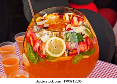 Fruit Punch In A Large Glass Bowl. Drink With A Variety Of Fruits Close Up. Orange Alcoholic Cocktail.