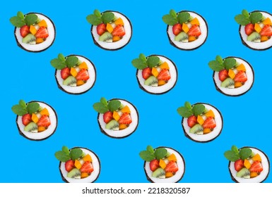 Fruit Salad In The Half Coconut On The Blue Background. Flat Lay. Pattern.