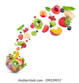 fruit salad ingredients in the air in a glass bowl isolated on white background - Shutterstock ID 299139917