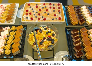 Fruit Salad And Large Selection Of Cakes Sweets At Buffet Table Choice