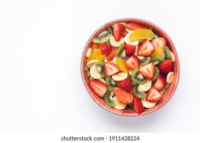 Fruit Salad In Pink Bowl On White Background. Banana, Orange, Kiwi, Strawberry. Healthy Eating 