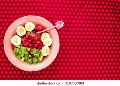 fruit salad: strawberries, kiwi, banana on a red tablecloth with polka dots - Powered by Shutterstock