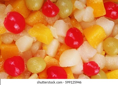 Fruit Salad Texture. Fruits As Background Pattern. Exotic Fruits  Fruit Salad With Cocktail Cherry Sour Cherry Mango Pineapple Grapes,pear,papaya In Syrup.