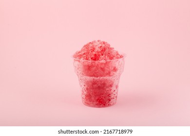 Fruit shaved ice in disposable plastic cup. Slushie - drink on pink background. Take away food. Refreshing summer drink. - Shutterstock ID 2167718979