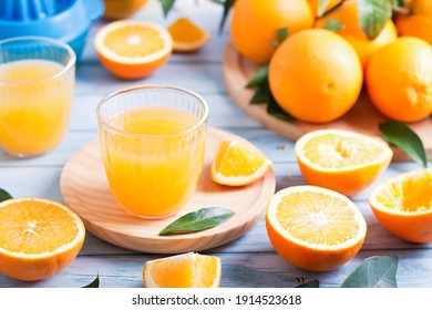 Fruit Squeezer And Ripe Fresh Oranges On Blue Wooden Table Top, Fresh Orange Juice Making, Overhead