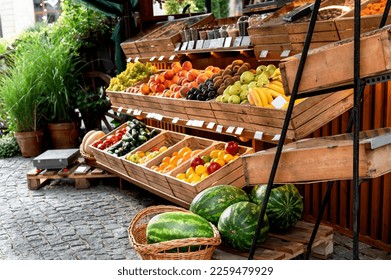 Fruit stand at a street market outside with organic watermelons, oranges, lemons in wooden crates small business vegan healthy food selective focus  - Powered by Shutterstock