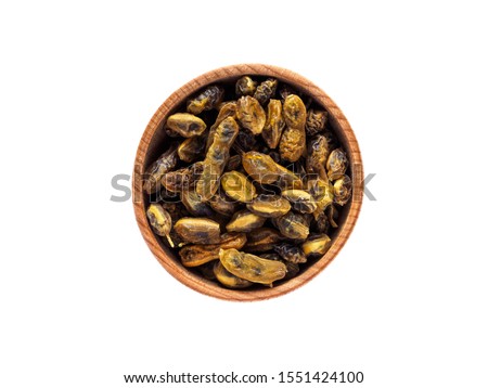 Fruit of Styphnolobium japonicum in a wooden Cup on a white background.