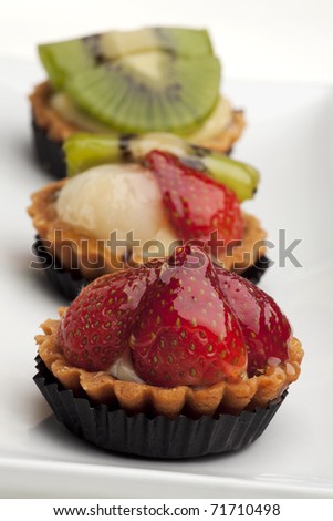 Similar – Image, Stock Photo Assorted gourmet pastries with fresh fruit toppings