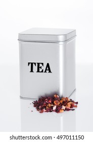 Fruit Tea Steel Jar With Loose Tea Next To It On White Background