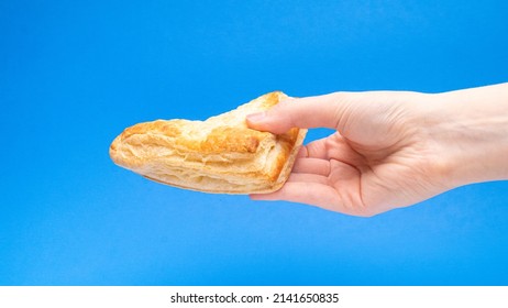 Fruit Turnover Pastry Angled In Hand On Blue Background