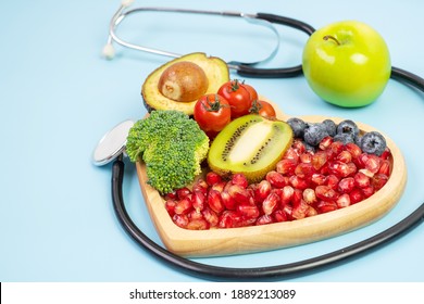 Fruit And Vegetable; Blueberries, Cherry Tomatoes, Avocado, Broccoli, Kiwi And Green Apple On Blue Background. Weight Loss, Nutrition, Healthy Food, Dieting And Vegetarian Concept