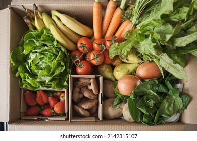 Fruit and vegetable delivery cardboard box. Fresh and organic grocery ingredients.