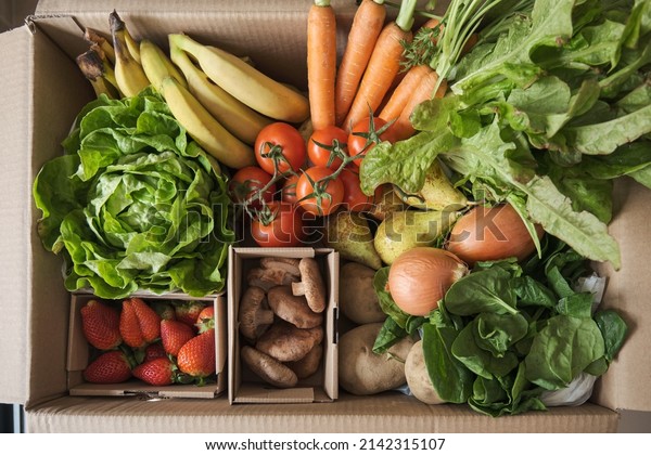 Fruit and vegetable delivery cardboard box.\
Fresh and organic grocery\
ingredients.