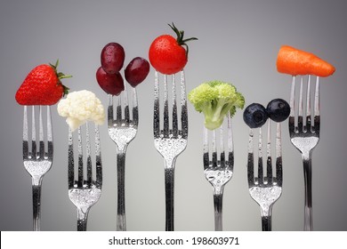 Fruit and vegetable of silver forks against a grey background concept for healthy eating, dieting and antioxidant - Shutterstock ID 198603971
