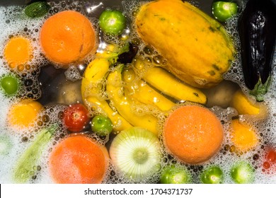 Fruit and vegetables washing in soapy water for coronavirus disinfection.