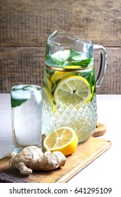 Fruit water with lemon, cucumber and mint in glass pitcher.