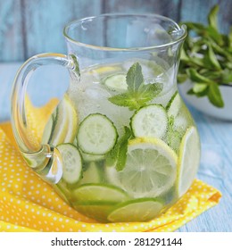 Fruit water with lemon, lime, cucumber and mint in glass pitcher
