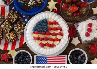 Fruitcake and various sweet foods arranged on wooden table with 4th July theme - Powered by Shutterstock